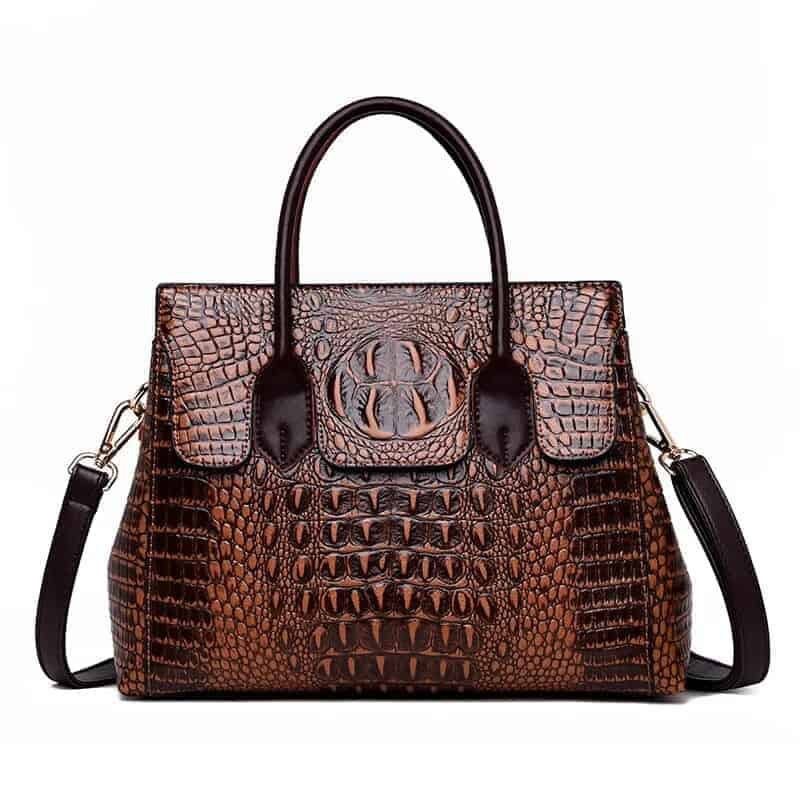 sac bandoulière en cuir Brun style rétro effet crocodile sur fond Vit