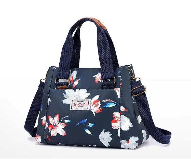 sac bandoulière Marinblå avec des fleurs sur fond Vit.