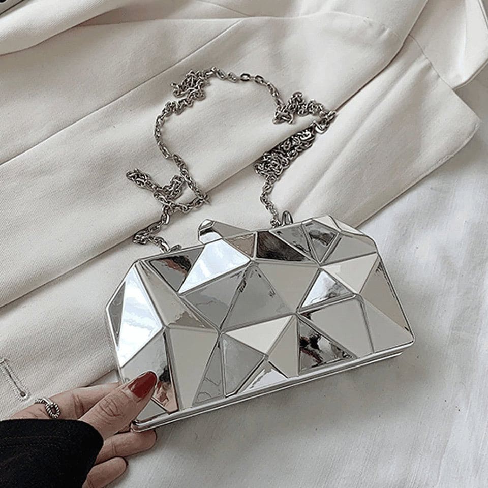 Geometrisk silver axelremsväska
