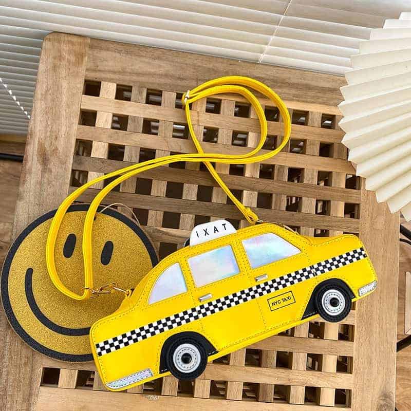 Gul axelremsväska i form av en taxi