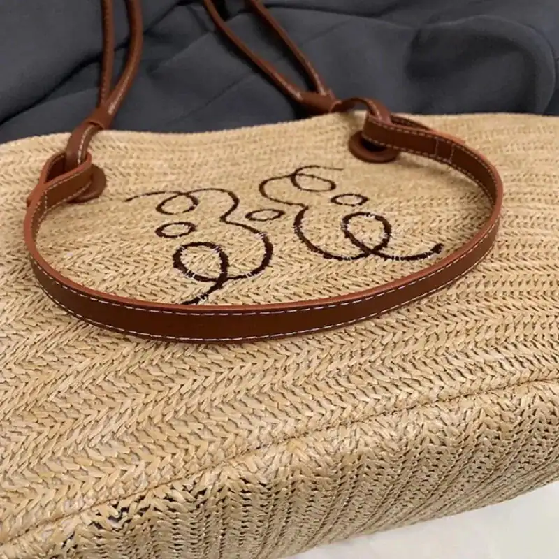 Beige stråkorg med bruna handtag och stiliserad text.