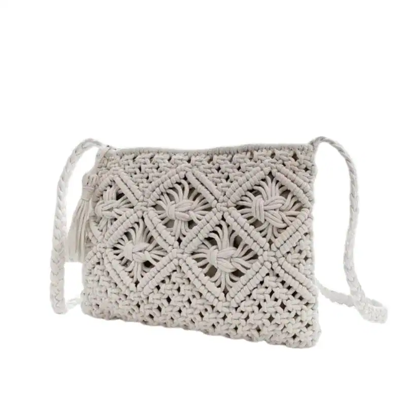 Brun makramé clutch med tasslar och broderad mönster.