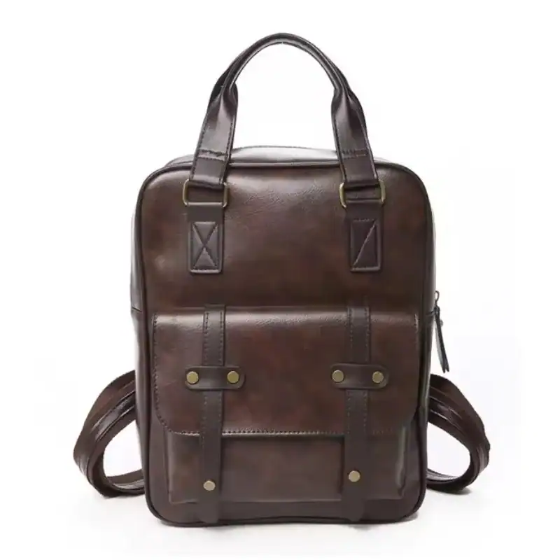 Brun skolväska med ryggsäck och handtag, vintage design.