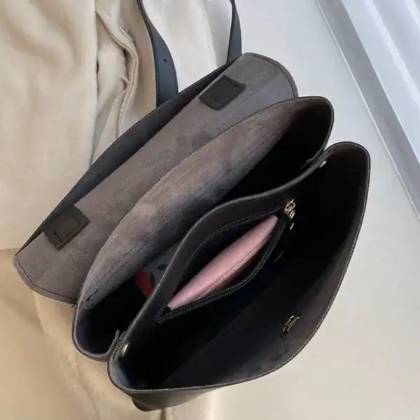 Brun Axelväska med handtag och rem, öppen inre med fickor och rosa plånbok.