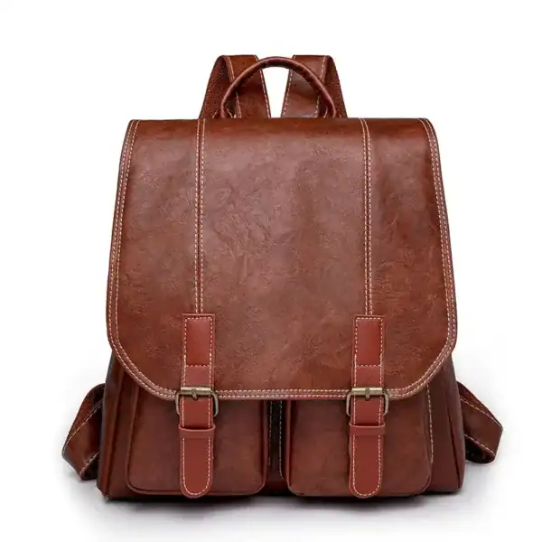 Brun vintage ryggsäck med läderliknande material och silverfärgade snäckor.