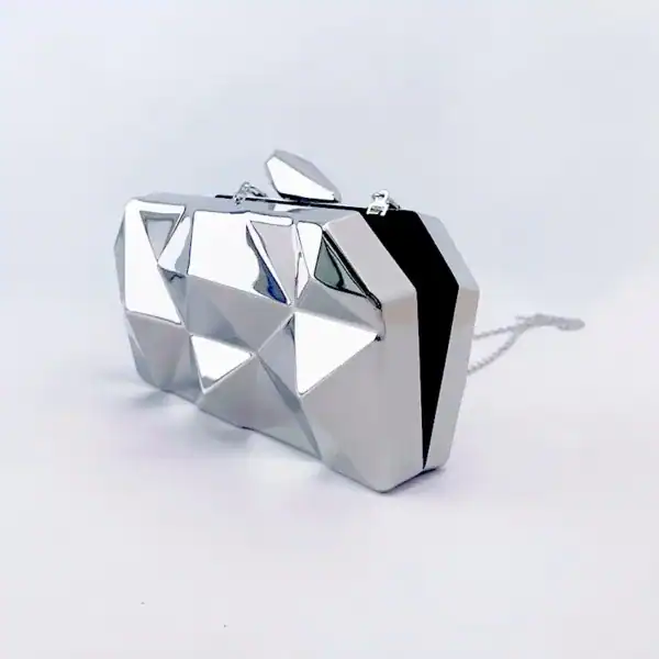 Guldig geometrisk clutch med silverfärgad yta och kedja.