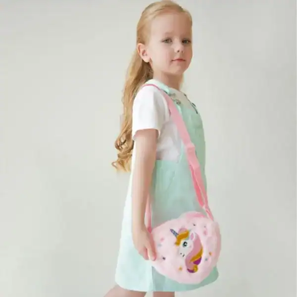 Liten flicka med rosa enhörningsväska i form av donut.