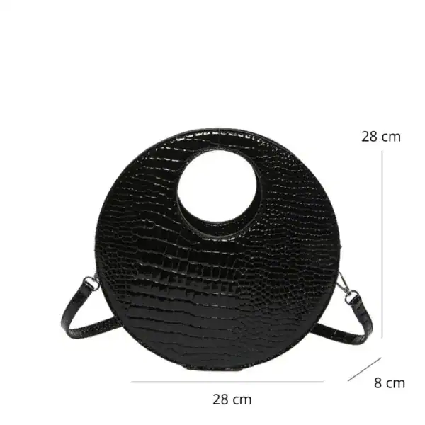 Svart rund axelväska med hål, krokodilsmönster, axelrem, 28 cm diameter.