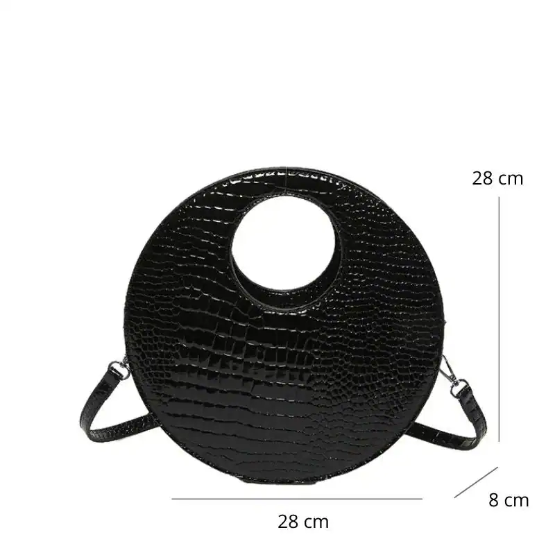 Svart rund axelväska med hål, krokodilsmönster, axelrem, 28 cm diameter.