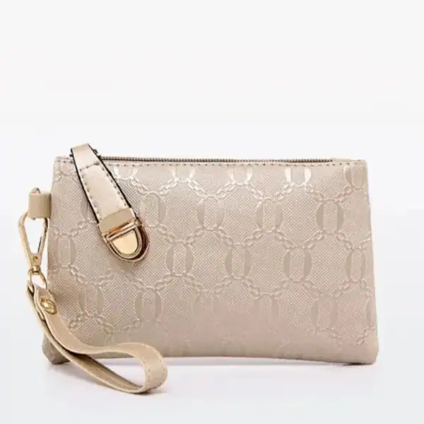 Stor handväska med axelrem, beige färg, eleganta mönster och metallförsedda dragkedja.
