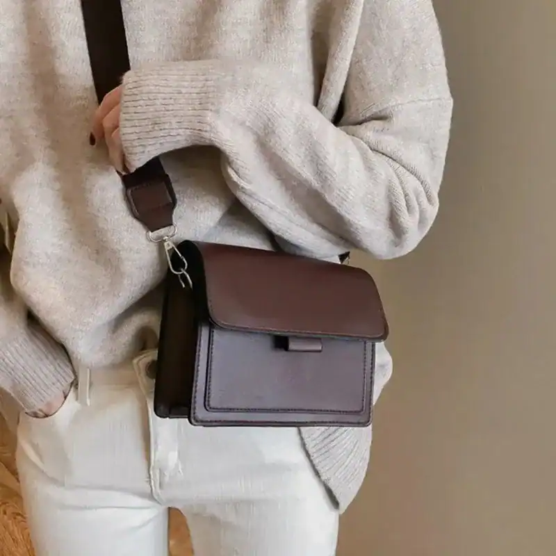 Svart liten väska med lock, axelväska i läder, modeaccessoarer för kvinnor.