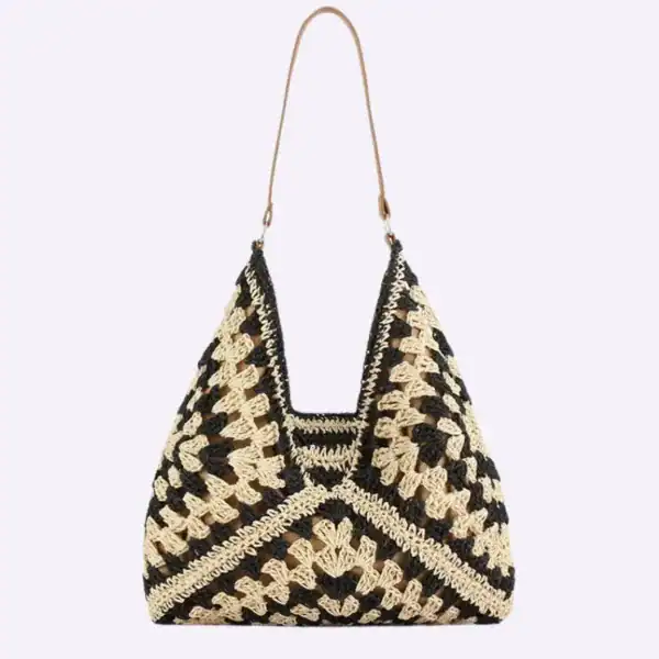 Virkad hobo väska i svart och beige, handgjord krochtdesign med lång axelrem.
