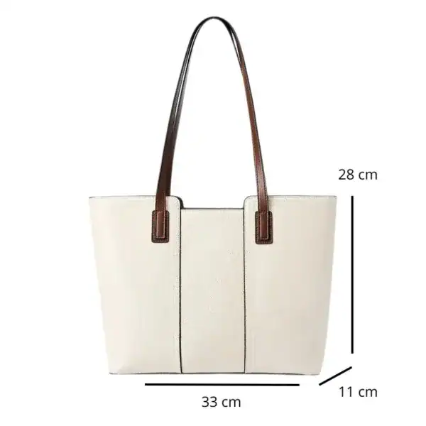 Vit shoppingväska med bruna handtag och mått 33x28x11 cm.
